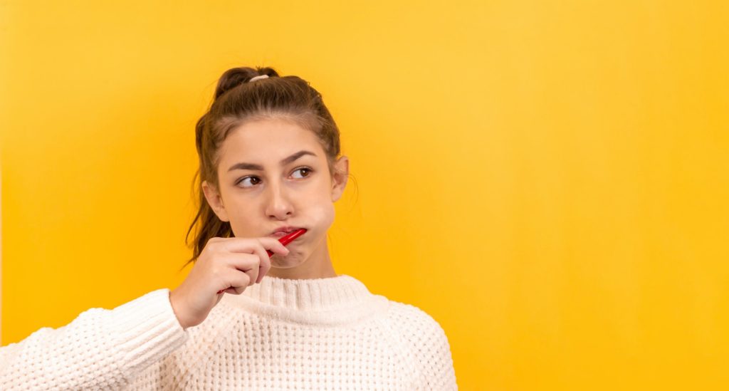 A young Girl Brushing her teeth